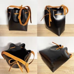Zweifarbige Leder crossbody und Schultertasche schwarz mit cognacbraunem Riemen und Band. Mittelgroße Bucket bag mit einem längenverstellbaren, praktischen Riemen. Elegante. leichte Damen Ledertasche handgefertigt, geeignet für jeden Tag.